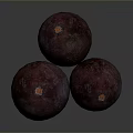Three Dark Red Round Textured Fruits With Orange Tops On Dark Background