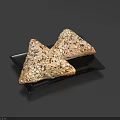 Two Triangular Oat Topped Pastries With Golden Crust On Black Plate