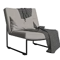 Light Beige Accent Chair with White Pillow Black White Checkered Blanket on Black Metal Frame
