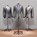 Three Classic Formal Suits On Mannequins With Brick Wall And Wooden Floor