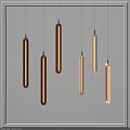 Modern Copper And Transparent Pendant Lights With Long Cylindrical Design Hanging On Gray Background