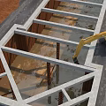 Construction Site Foundation Framework With Concrete Structure And Excavator Working