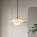 Pleated White Pendant Light With Minimalist Wall And Green Plant Accent