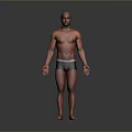 Bald Head Man Standing Shirtless In Dark Shorts On Gray Background
