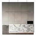 Minimalist Reception Desk with Marble Countertop Gray Wall and Hanging Light Fixture in Modern Design