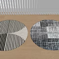 Round Rugs With Black And White Geometric Stripes And Textured Patterns On Light Wooden Floor