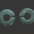 Two Green Notched Circular Artifacts With Blue Green Surface Patterns