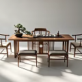 Traditional Wooden Tea Table and Chairs in Minimalist Setting With Potted Plant and Tea Set