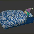 Blue Cushion Featuring White Geometric Pattern And Small Doll With Pink Hat