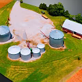 Aerial View Of Rural Farm With Multiple Silos Red Barn Green Grass And Trees