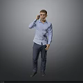 A Man Talking on the Phone in Blue Shirt and Dark Pants Against Gray Background