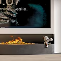 Modern Fireplace With Burning Flames And Small Decorative Figure Sitting On Edge