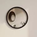 Round Mirror with Black Beaded Frame on White Wall Reflecting Circular Object and Plant 3d model
