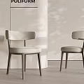 Modern Sleek Dining Chairs With Light Upholstery And Wooden Legs In Minimalist Interior