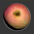 Fresh Ripe Red and Yellow Apple on White Circular Base Against Dark Background