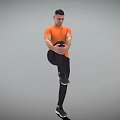 Man Standing on One Leg Holding Knee in Orange T-shirt Black Pants Sneakers Gray Background