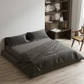 Double Bed with Gray Bedding Wooden Nightstand Wicker Chair White Walls Wooden Floor Stone Shelf