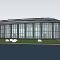 Modern Circular Glass Building Exterior With Scenic Waterfront And Green Grass