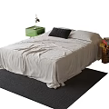 Double Bed with Light Colored Bedspread Black Pillow and Green Nightstand on Dark Carpet