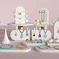 Elegant Jewelry Display On White Stands With Various Necklaces Bracelets And Gemstone Rings