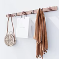 Wooden Wall Hook with Woven Bag Gucci Shopping Bag and Brown Scarf on Beige Wall