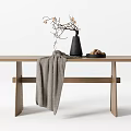 Simple Wooden Dining Table With Black Vase Branches Gray Blanket And Nut Plate