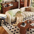 Beige Curved Sofa With Green Brown Cushions And Wooden Round Coffee Table On Geometric Rug