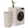 Siemens Front Load Washing Machine With Patterned Laundry Basket And Green Plant Vase
