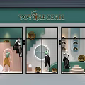 Stylish Store Window Display With Clothing Mannequins Circular Decorations And Green Signage