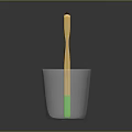 Children's Toothbrush With Yellow Handle Green Bottom Brown Bristles In Glass Cup