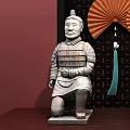 Terracotta Warrior Sculptures Kneeling And Standing With Red Fan And Dark Frame On Wooden Table