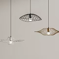 Three Modern Unique Design Pendant Lights Hanging On Light Colored Wall Interior
