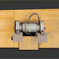 Vintage Bench Grinder Equipment on Yellow Wooden Base with Dark Background and Reflection