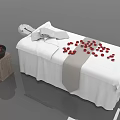 Massage Bed with White Sheets Gray Sash and Red Petals Near Stone Pedestal Black Bowl