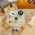 Decorative Ornaments Display On Coffee Table With Book Plant Pastry And Plush Toy