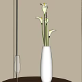 White Vase with White Calla Lilies Next to Wine Glass on Wooden Table Home Decor