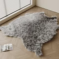 Gray Furry Shaped Rug On Wooden Floor With Open Magazine And Window Blinds