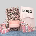 Floral Decoration Setup With Pink Floral Wall Sofa Gift Boxes And Bow Background Board