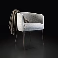 Gray Fabric Armchair With Brown Blanket Draped Over Armrest And Wooden Legs