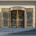 Golden Revolving Door Entrance With Glass Panels And Stone Facade Design