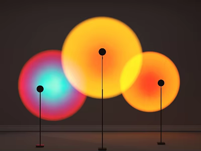 Three Modern Floor Lamps with Circular Glowing Colorful Shades and Black Stands Against Gray Wall 3d model