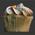 Delicious Cupcake With White Frosting And Colorful Sprinkles On Paper Liner