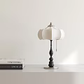 Modern Table Lamp With White Lampshade Black Post And Silver Base On Table Near Books