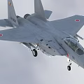 Gray Fighter Jet Flying With Weapons And Landing Gear Down In Blue Sky