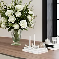 Green Glass Vase With White Flowers And Decorative Candles On Wooden Table By Window