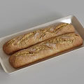 Two Freshly Baked Baguettes With Golden Crust On White Rectangular Plate