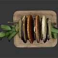 Assorted Colored Bread Slices Displayed on Wooden Tray With Green Leaf Accents