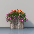 Decorative Potted Plant In Wooden Planter With Orange And Pink Flowers And Green Leaves
