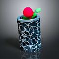 Small Green Plant With Red Top In Black Pot Featuring White Circular Patterns