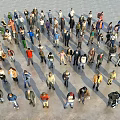 Large Group of People with Various Postures in Open Public Area